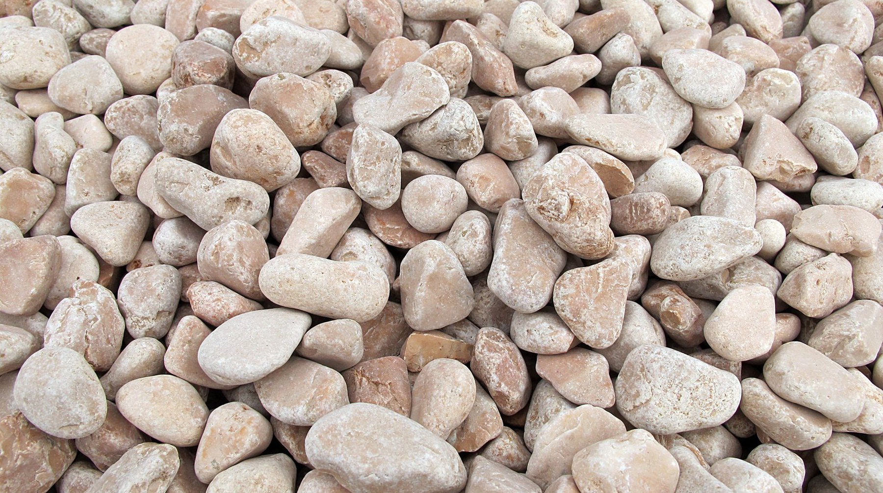 Zierkies aus Naturstein in hellen Beigetönen, Rundkies aus der Nähe