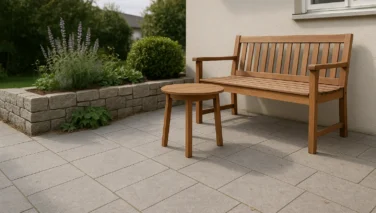 Stimmiger Sitzplatz im Garten mit Natursteinplatten, Pflanzen und Holzmöbeln